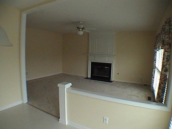 Family Room with bright windows adjacent to kitchen