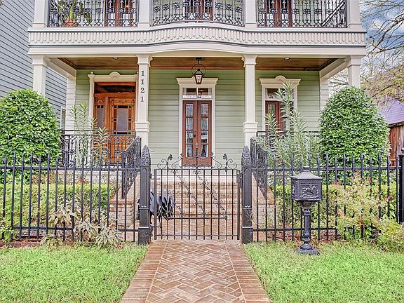 A paved walkway leads through the iron gate up to the covered porch. The durable, low-maintenance hardi plank exterior withstands anything Houston weather throws at it!