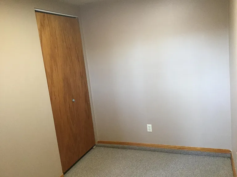 Small bedroom with closet and window.