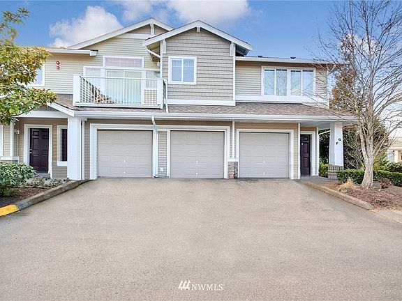 Home is around to the right. The garage is the middle garage door.