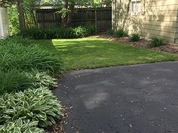 West side of garage with small yard.