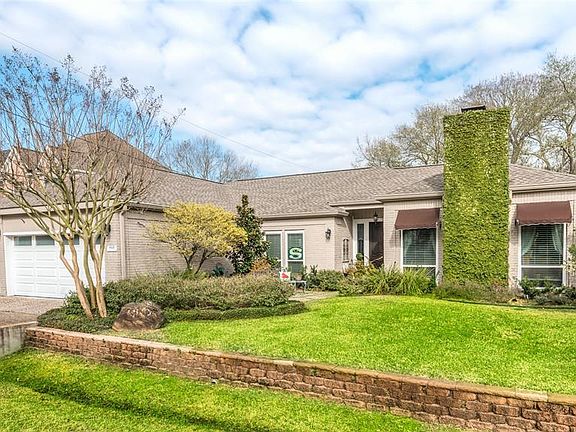 Charming landscaping wraps this home in color and makes the curb appeal so cheery. Flowering trees, blooming shrubs and perennials make this front scenery so welcoming. Full sprinkler system installed in front and back.