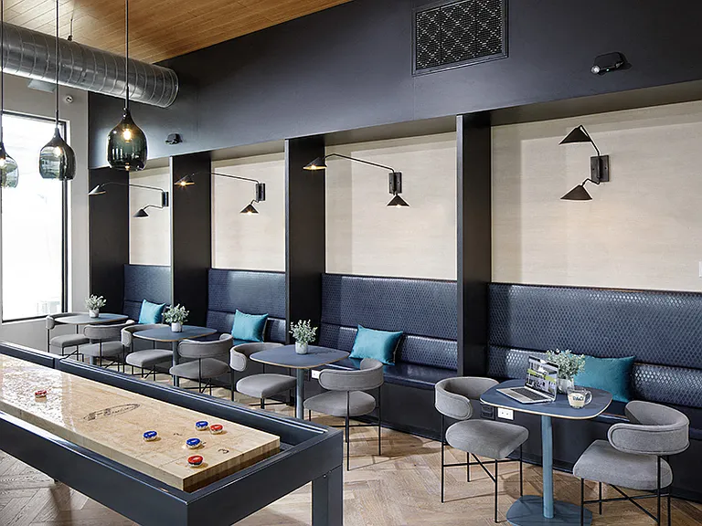 The game room features a lounge-style seating area and social environment