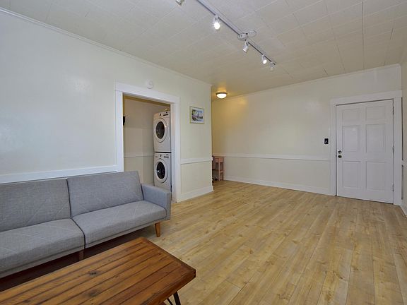 updated LARGE studio with many windows, furnished with in-unit laundry machines