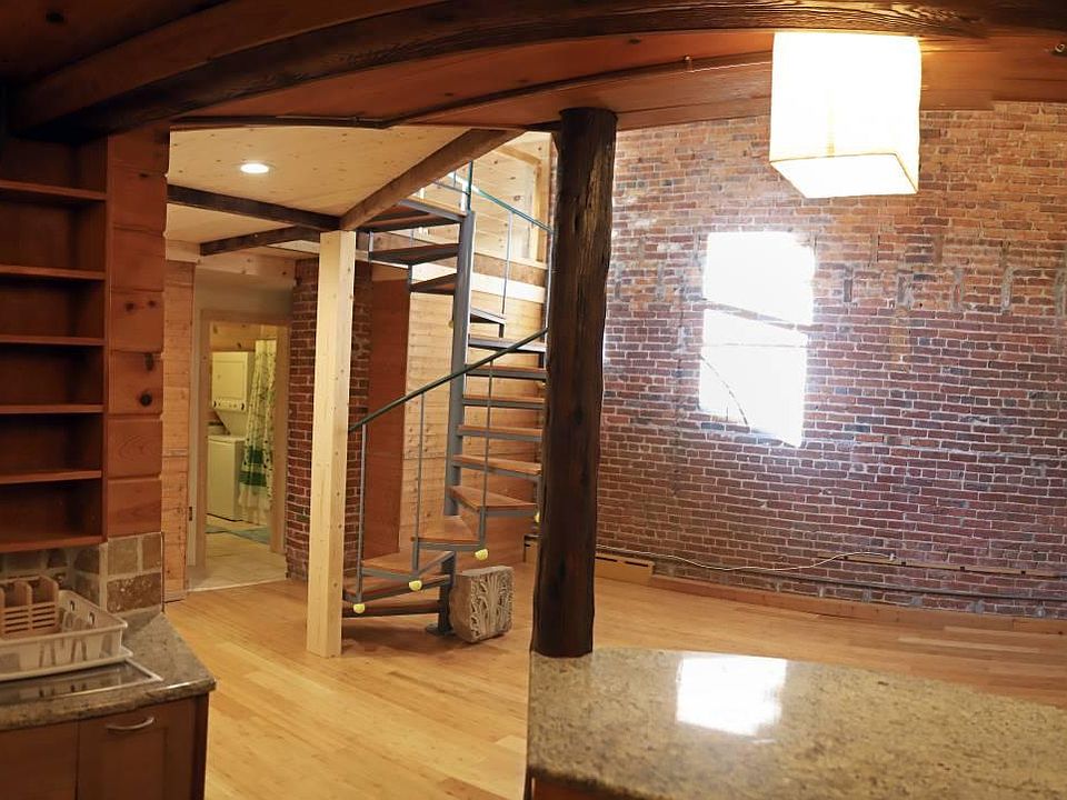 View from kitchen looking into back of great room, and bathroom to the left.