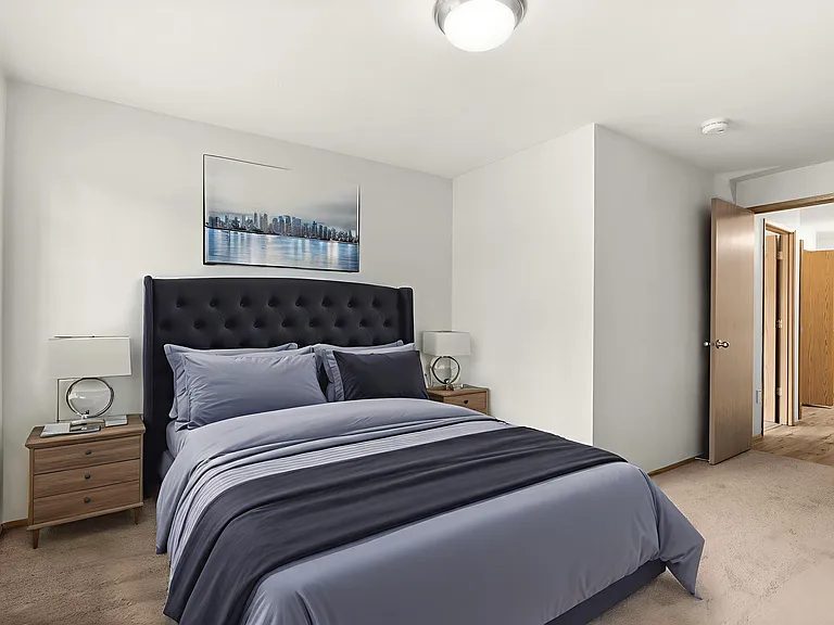 Cozy bedroom, virtually staged to highlight a stylish bed setup, warm decor, and soft carpet flooring. Cozy bedroom, virtually staged to highlight a stylish bed setup, warm decor, and soft carpet flooring.