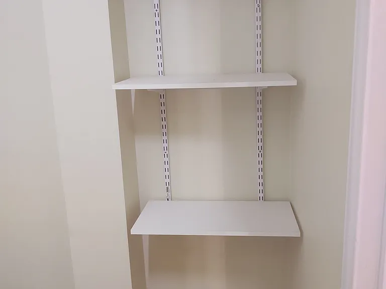 Bedroom #1 with walk in closet with built in shelves.