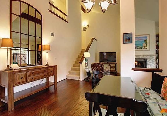 Living Room w/hewn wood floors and soaring ceiling. Stairs are now hardwood to match floors...carpet removed!