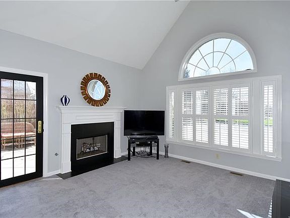 The living room is enhanced by a cathedral ceiling with fan and a fireplace.   Access to the courtyard is also provided from thi