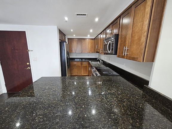 Full Kitchen with ample cabinets and wrap around counter