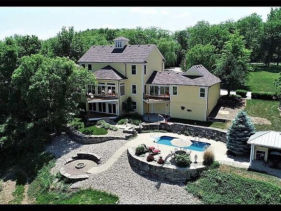Rear view of the property with pool, cook pavilion, fire pit and more.   Those decks offer amazing views!