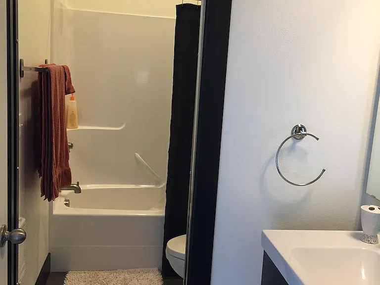 The upstairs bathroom has a pocket door between the shower/toilet area and the sink.