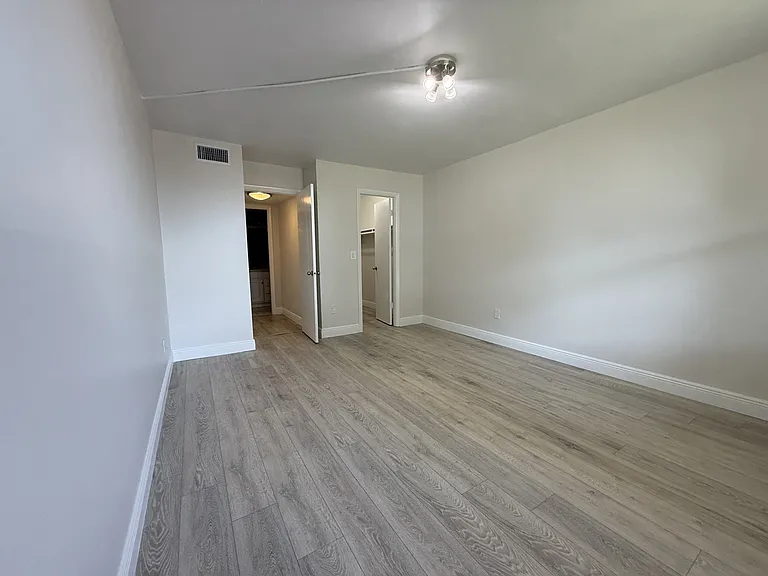 Bedroom and a large walking closet with a new wood floor