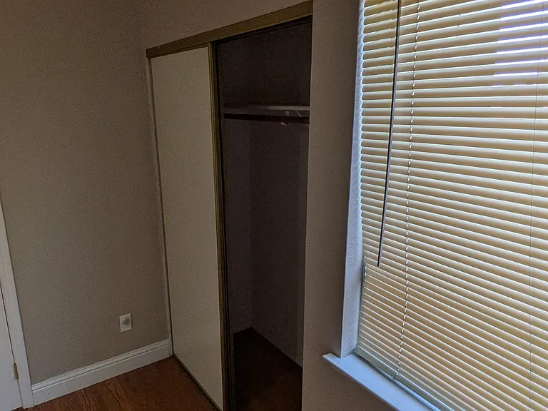Bedroom 1 (upstairs) with window overlooking backyard