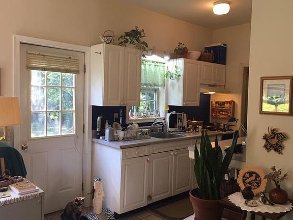 Galley kitchen with door to backyard