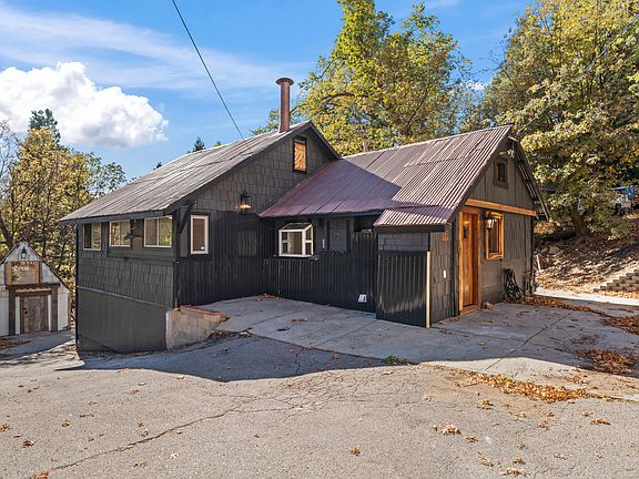 SIDE OF MAIN HOME WITH SEPARATE THREE LEVEL BUILDING TO THE LEFT.