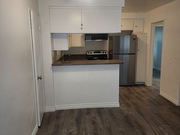 Entry and dining area. Plank flooring, fresh paint, no popcorn ceiling with fan.