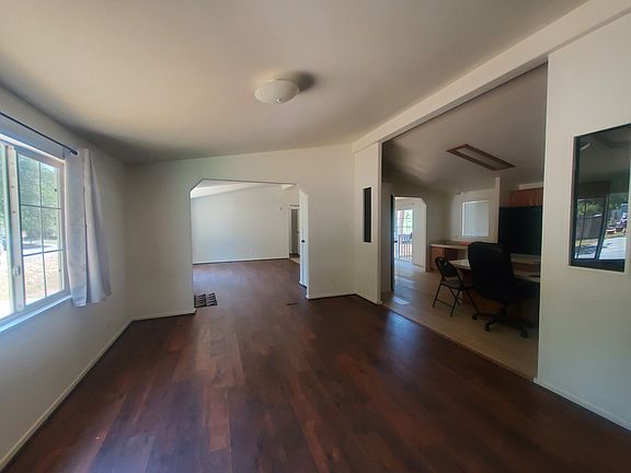 Living room 1 looking towards the second living/family room with kitchen to the right.