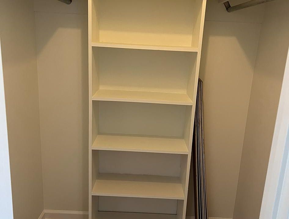 Large walk in closet with shelving