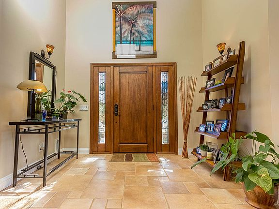 The foyer features soaring ceilings, premium tile floors & designer paint colors throughout...