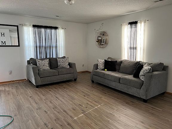 Living Room: Sample furnishings and updates in progress to flooring