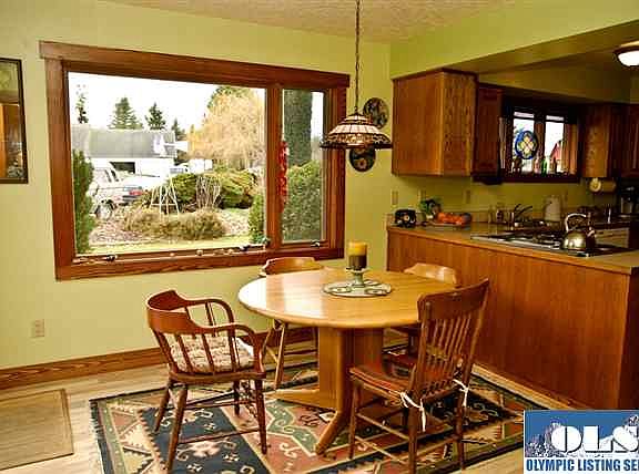 Dining nook is off the kitchen and is light and bright. Wood wrapped windows and wood trim everywher
