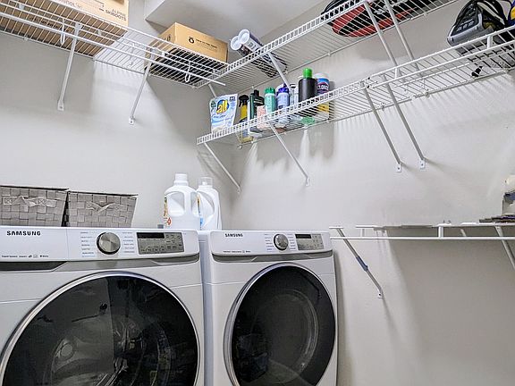 Laundry room with storage shelves