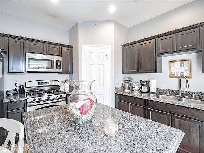 Kitchen granite island with view of kitchen.