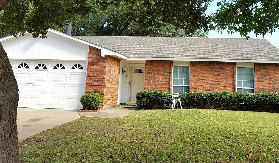 Manicured yard with Garage