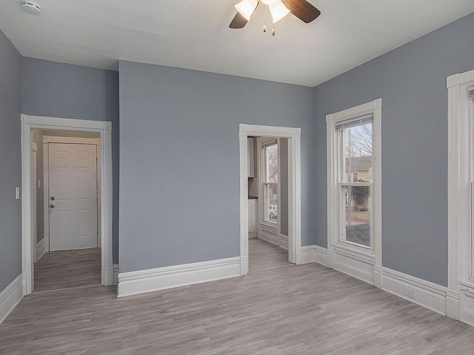 The left door is the entry door, entry way with storage closet, view is the living room looking towards the kitchen