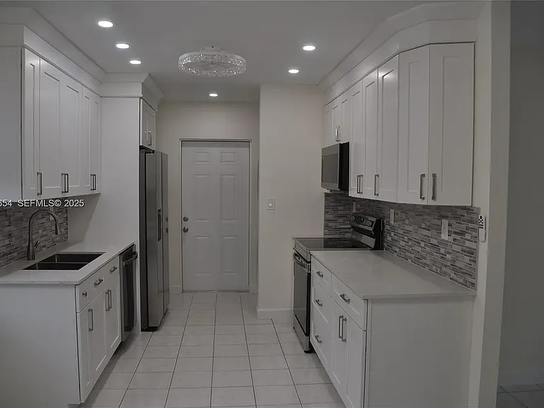 571 NE 61st St — Photo 38