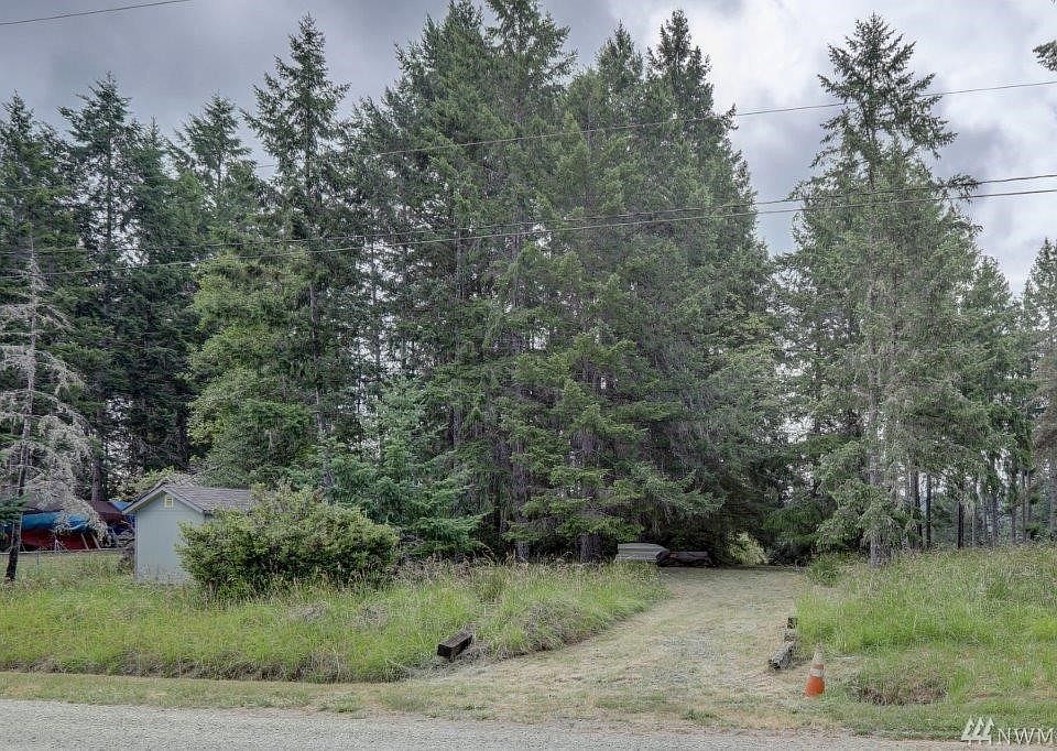 Private Herron Island with Private ferry access to the island. Vacant lot with water meter on the property. Seller had long gravel driveway brought into the property. There is a cleared level area in the middle of the lot for camp trailer or tents. To the right of the lot is a storage shed. Back of the lot has partial sound view. 