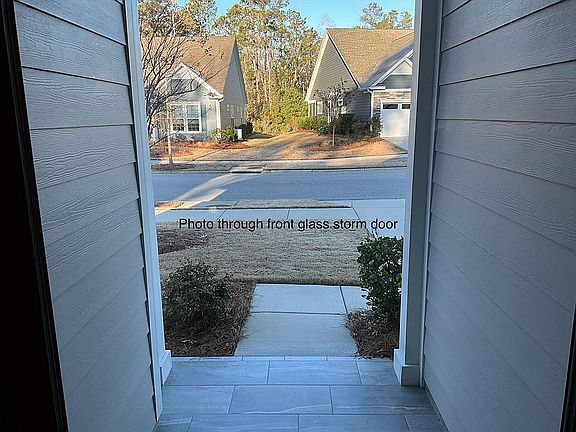 Thru front glass storm door