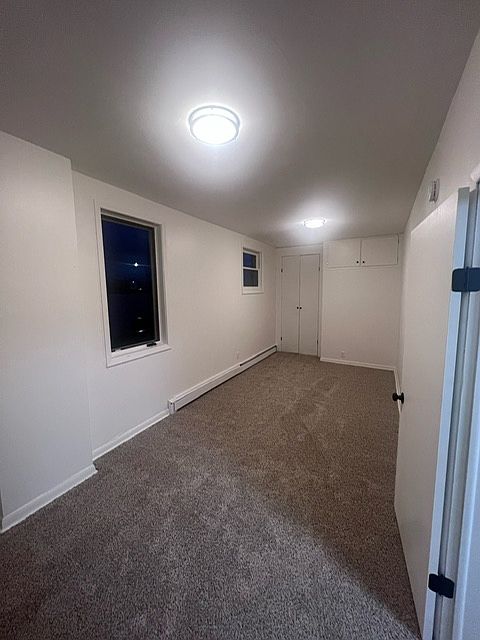Another bedroom photo showing another closet and storage space above.