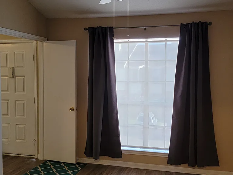 First bedroom with tall high ceiling fan