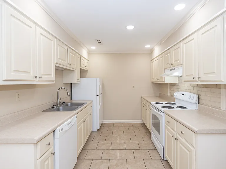 Large kitchen with lots of cabinets and counter space. All appliances: stove, refrigerator, dishwasher.