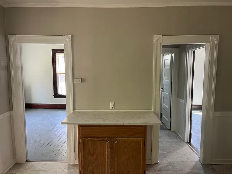 Kitchen to bedroom number three (left) and bathroom, bedroom number two (right)