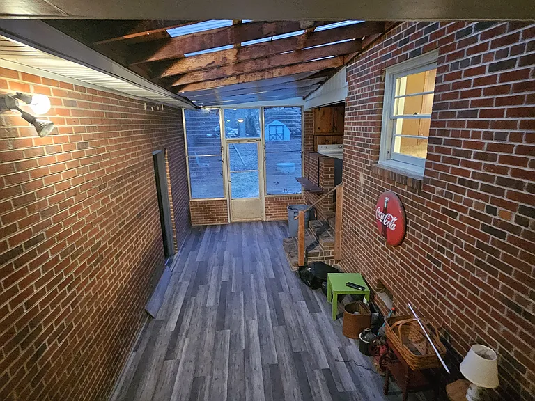 Lower enclosed porch with LVP flooring.