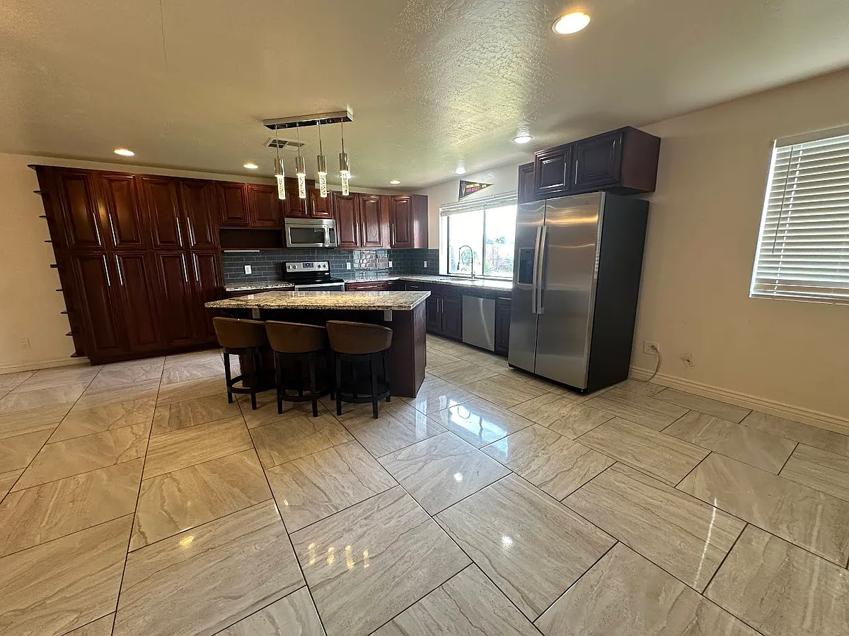 Large open concept kitchen with pendant lights and granite countertops - 1817 E Concorda Dr