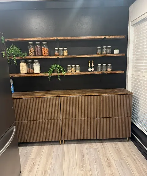 Beautiful cabinetry and open storage at one end of the kitchen.
