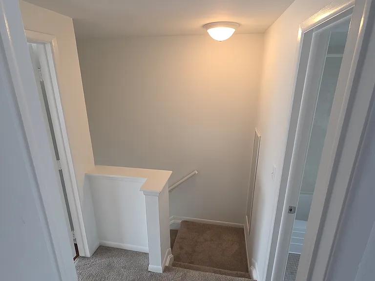 Freshly painted second-level hallway and stair landing.
