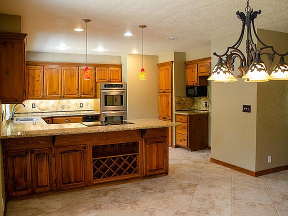 Kitchen with double oven and breakfast nook. Built in wine rack. Lots of cabinets for storage.