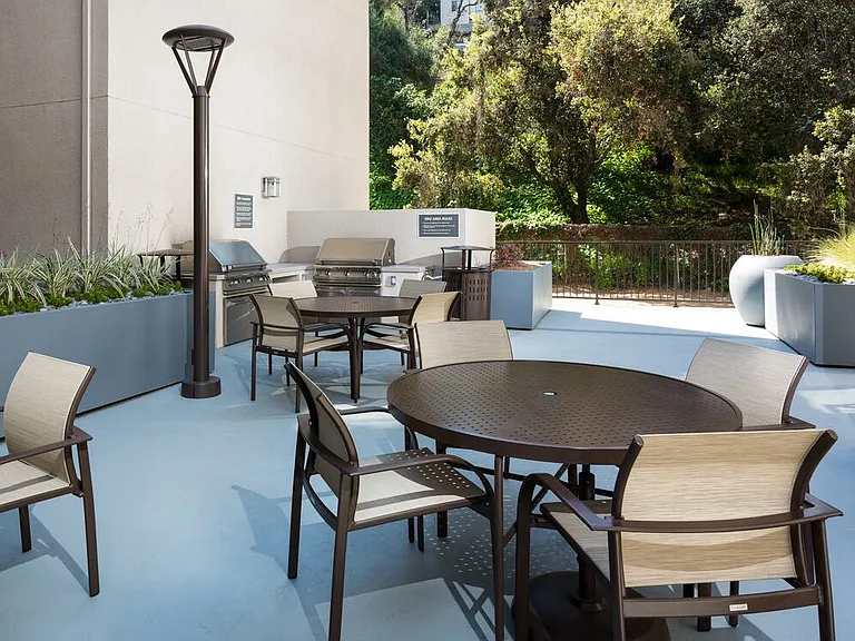 Resident courtyard with barbecue grills, fire pits, and lounge seating