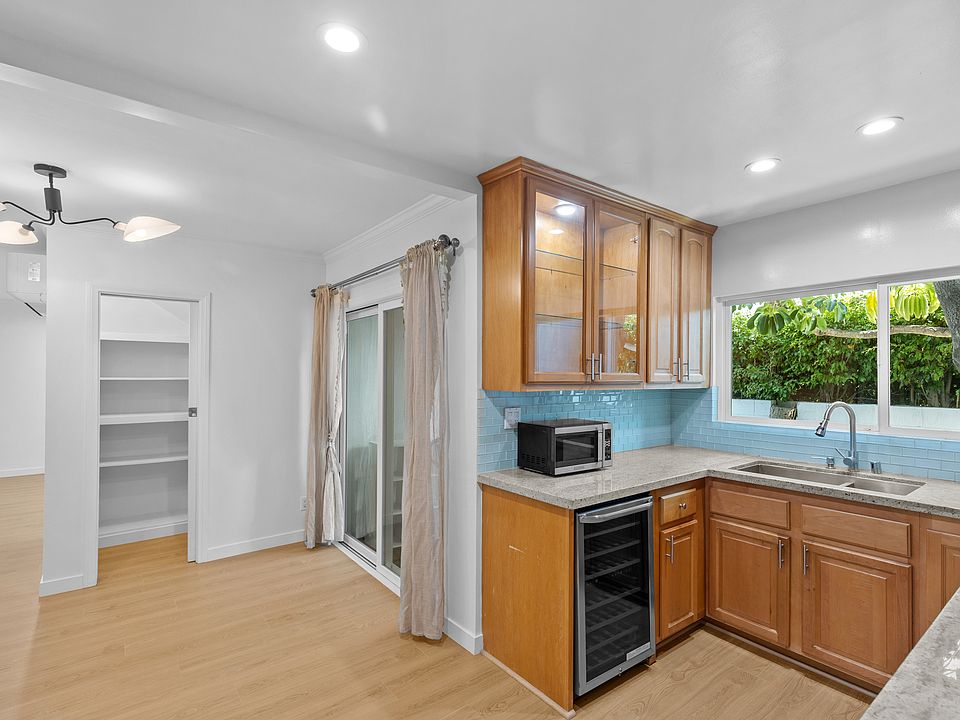 Bar area with wine fridge and light up cabinet above