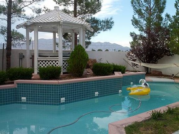 Pool with hot tub in gazebo.