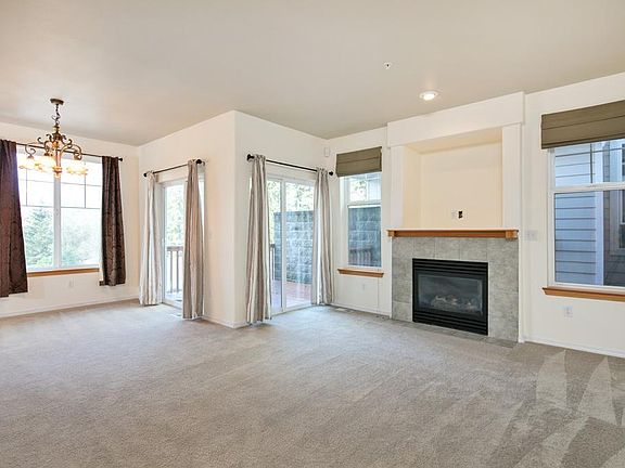 Open living and dining room with deck access from both sides