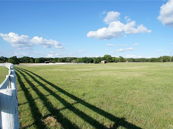 Lush coastal pastures with loafing sheds.