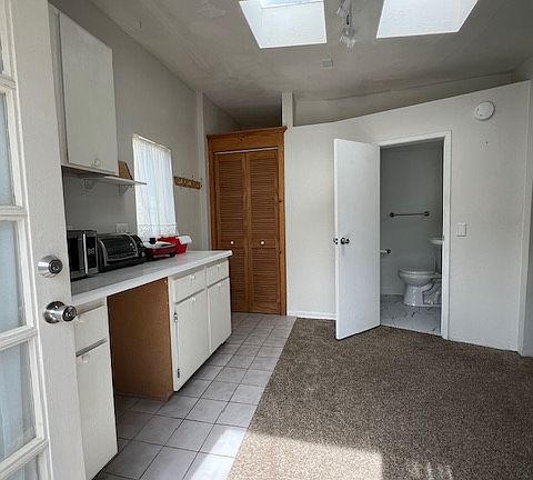 Kitchen area, closet and bathroom entrance
