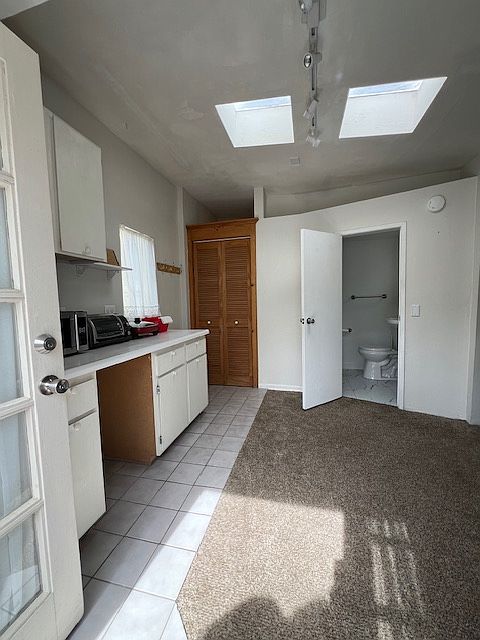 Kitchen area, closet and bathroom entrance