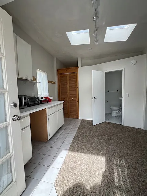 Kitchen area, closet and bathroom entrance